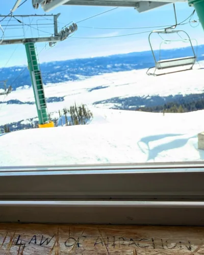 The chairlift and the snowy view through a window.