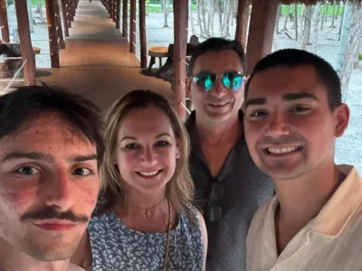 A group selfie in a covered outdoor walkway.
