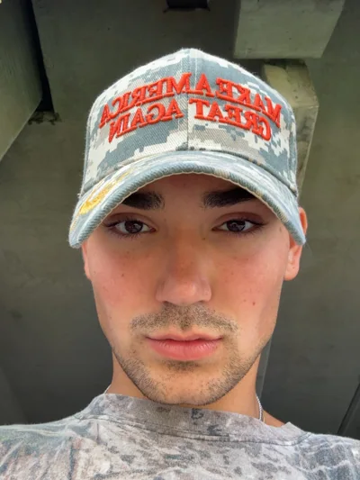 A casual close-up portrait wearing a baseball cap.