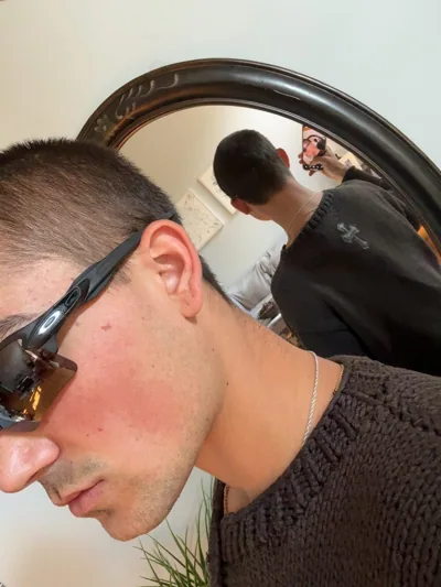 A side-profile reflection with sunglasses.
