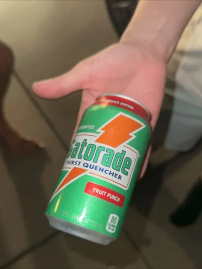 A green fruit-punch can held in one hand.