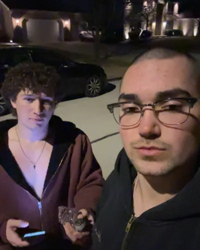 Two people in a casual night-time selfie.