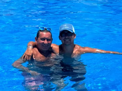 Two people together in bright blue water.