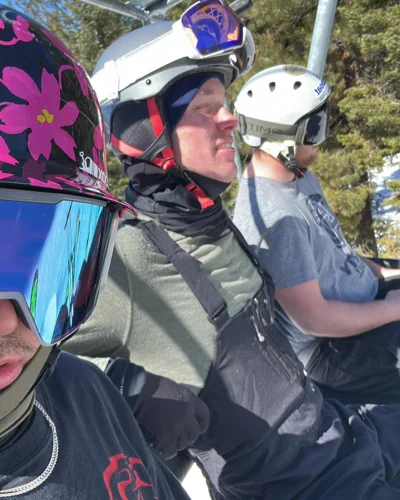 Riders sitting together on a chairlift.