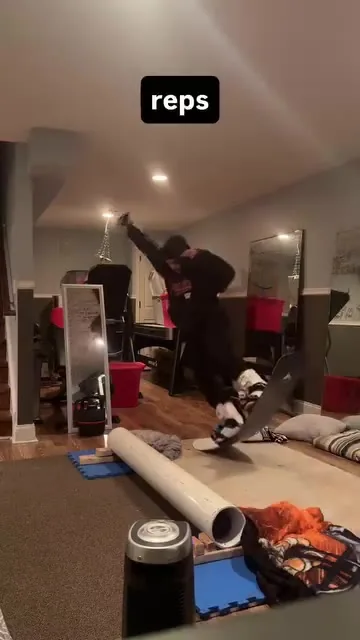 A short edit of repeated indoor snowboard practice attempts.