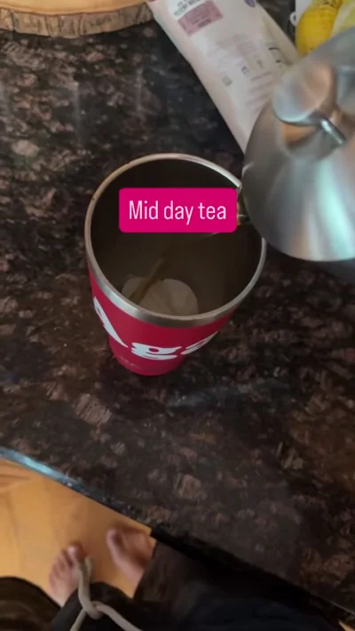 Tea press and red cup in the same kitchen setup.