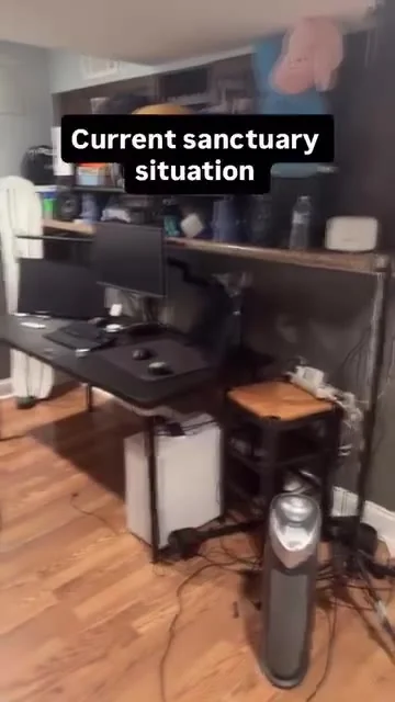 Desk with dark monitors, shelving, cables and wooden floor; another reviewed frame shows a dresser and weights.